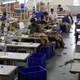 Workers stitch garments at a factory of an apparel shop in Jaipur, India